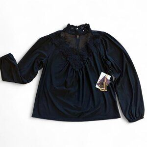 Black long sleeve blouse with high neck and lace/mesh trim.